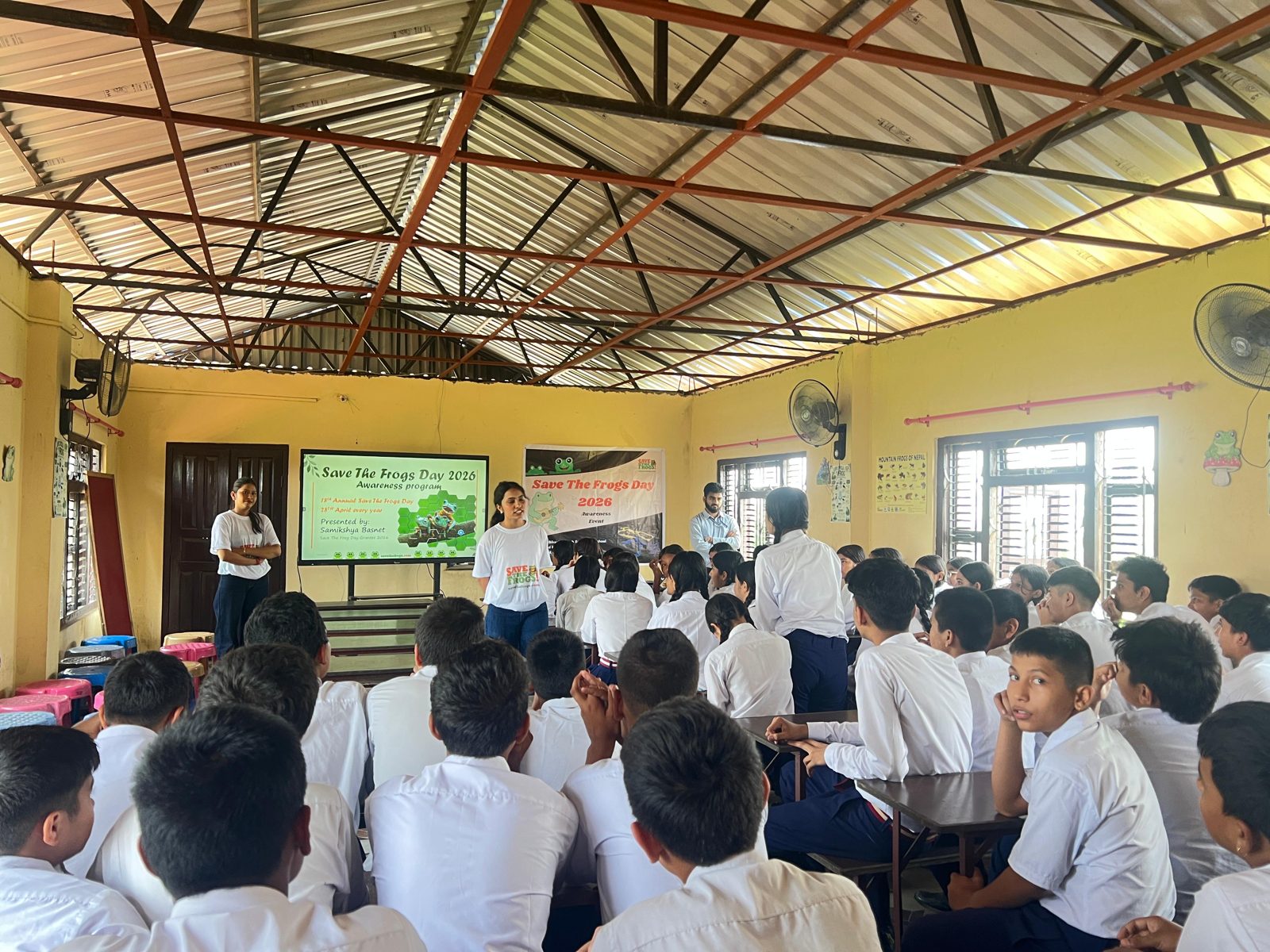 Samikshya Basnet presenting a Save The Frogs Day session to a school hall of students