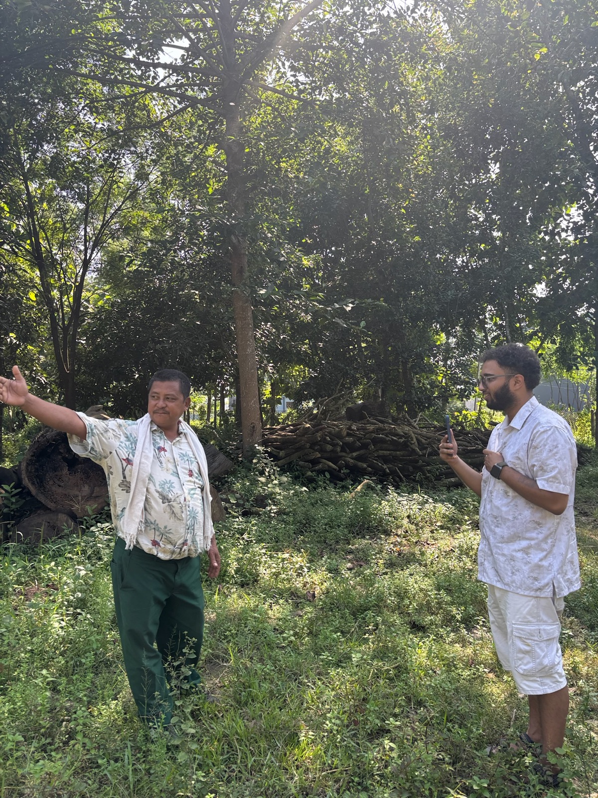 Hemanshu Kafle listening as a forest user group member describes the stand, Kawasoti